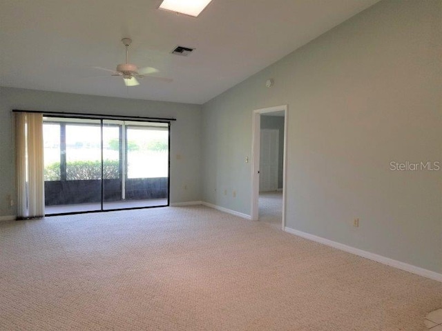 carpeted spare room featuring ceiling fan and lofted ceiling