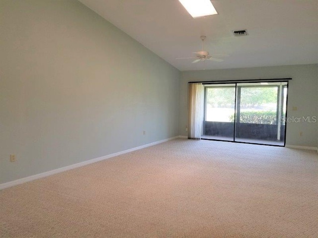 carpeted empty room featuring ceiling fan and lofted ceiling