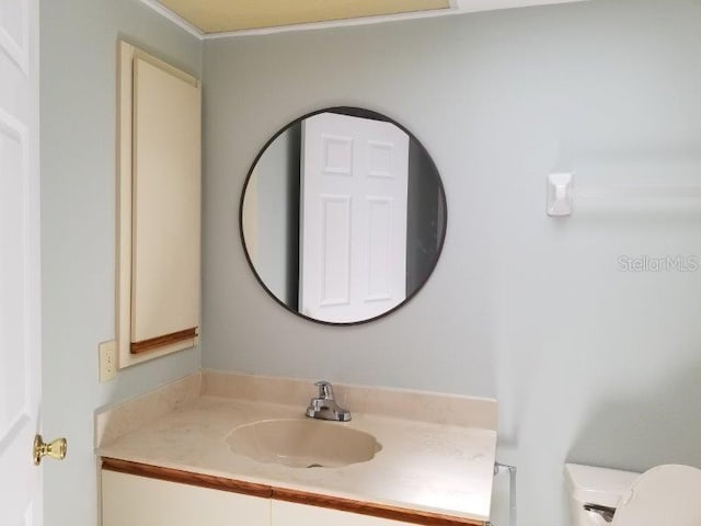 bathroom featuring vanity and toilet