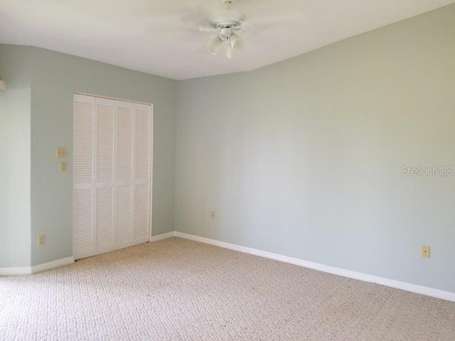 unfurnished bedroom featuring ceiling fan, carpet floors, and a closet