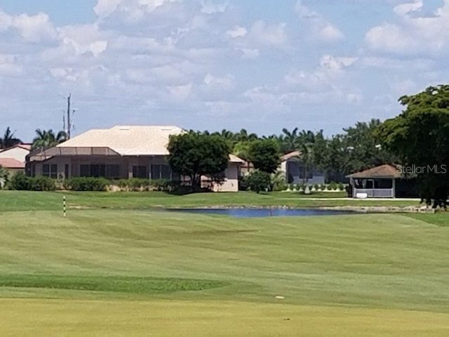 view of home's community with a lawn and a water view