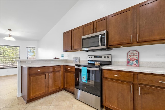 kitchen with pendant lighting, lofted ceiling, light tile patterned floors, kitchen peninsula, and stainless steel appliances