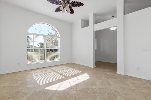 empty room featuring ceiling fan and light tile patterned floors