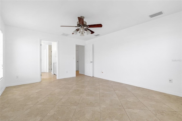 empty room with ceiling fan and light tile patterned flooring