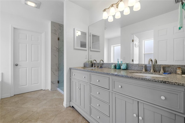 bathroom with vanity, tile patterned floors, and a shower with door