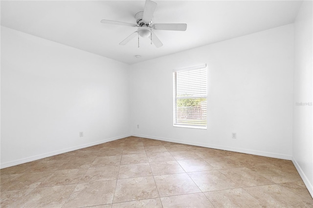 tiled empty room featuring ceiling fan