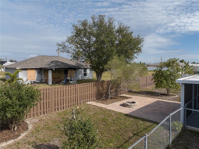 view of yard with a patio and an outdoor fire pit