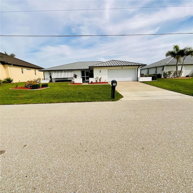 view of front of house with a front yard and a garage