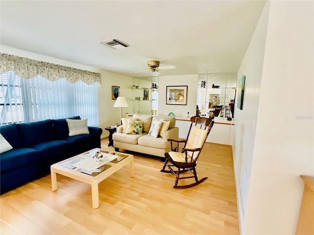 living room with hardwood / wood-style floors and ceiling fan