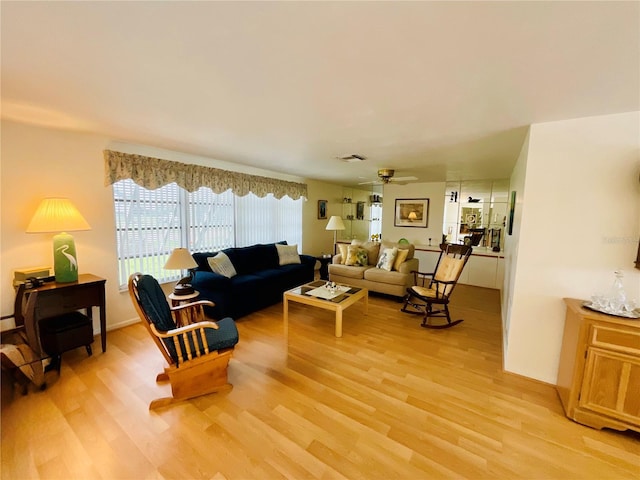 living room featuring light hardwood / wood-style flooring and ceiling fan