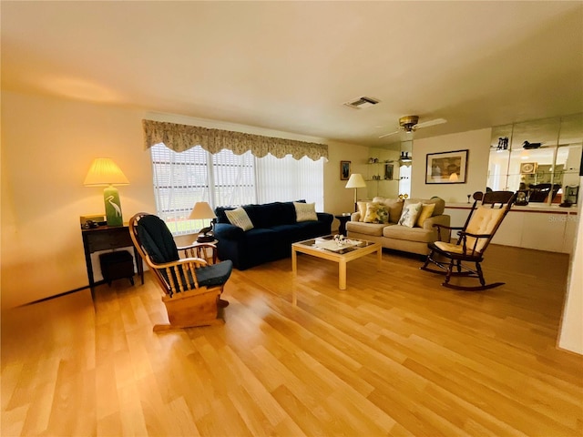 living room with hardwood / wood-style floors and ceiling fan