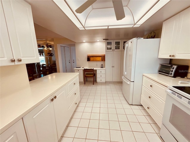 kitchen with white cabinets, ceiling fan, light tile patterned flooring, and white appliances