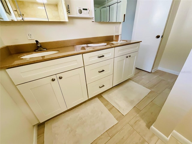 bathroom featuring vanity and hardwood / wood-style floors