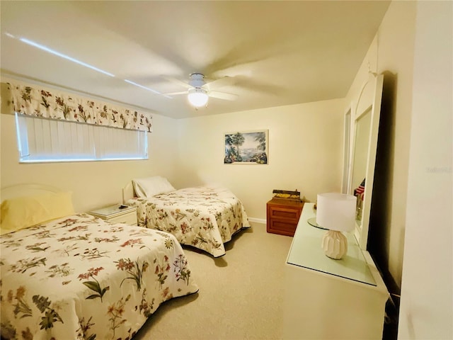 bedroom with ceiling fan and light carpet