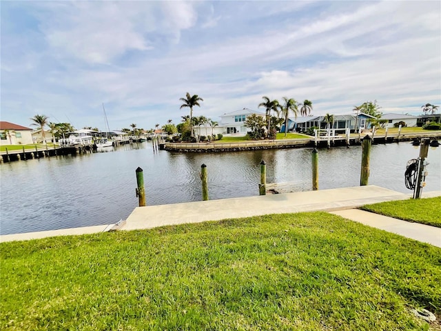 view of dock featuring a water view and a lawn