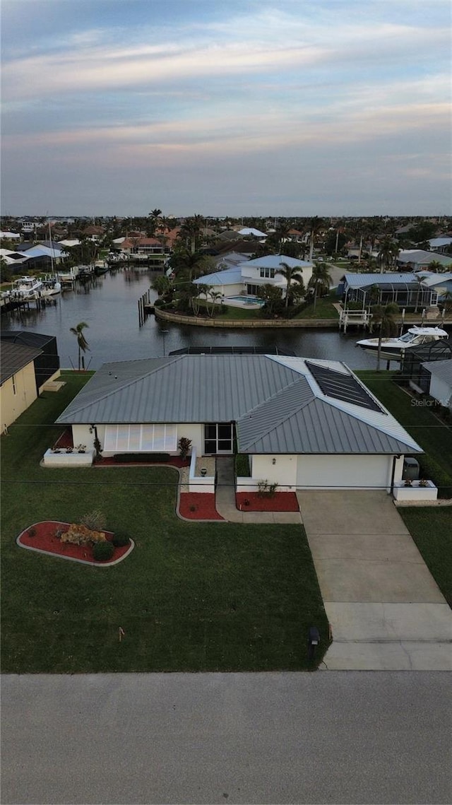 aerial view at dusk with a water view