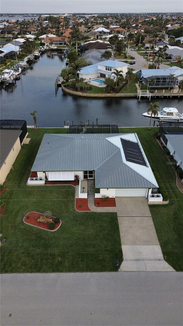 view of dock featuring a water view and a lawn