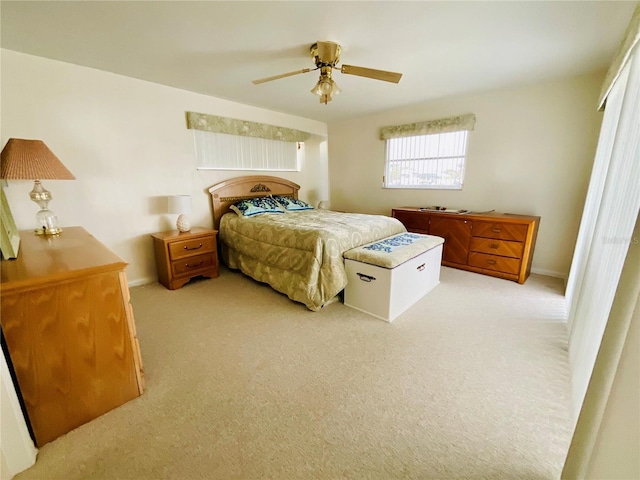 bedroom with ceiling fan and light colored carpet