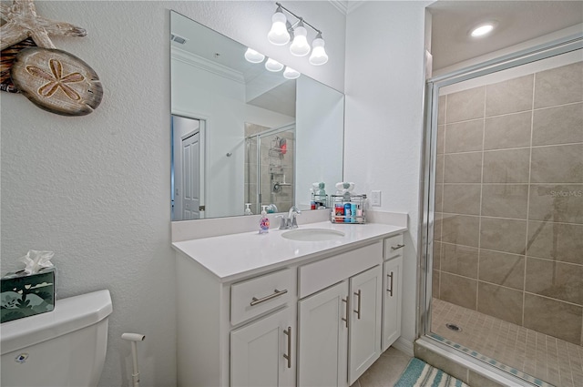 bathroom with vanity, toilet, and a shower with shower door