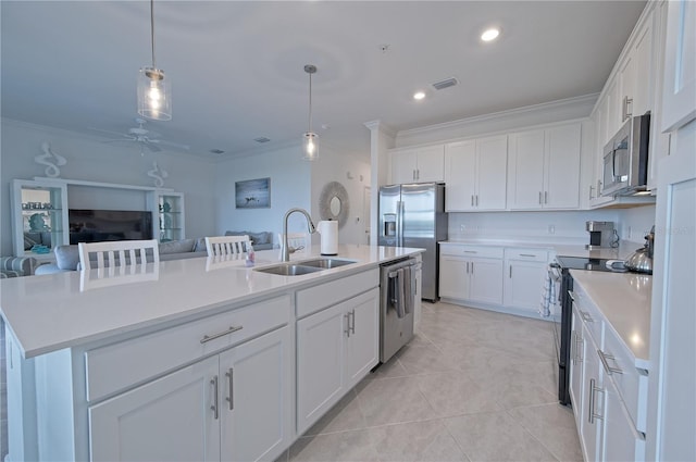 kitchen with sink, pendant lighting, a center island with sink, white cabinets, and appliances with stainless steel finishes