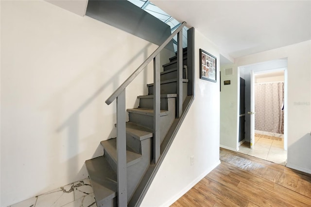 stairway featuring wood-type flooring