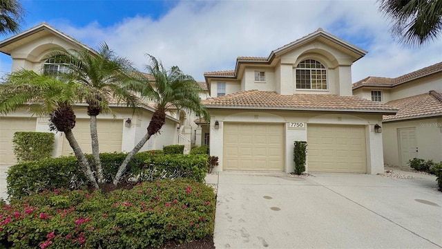 mediterranean / spanish-style home with a garage