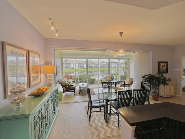 dining area featuring light tile patterned floors and track lighting