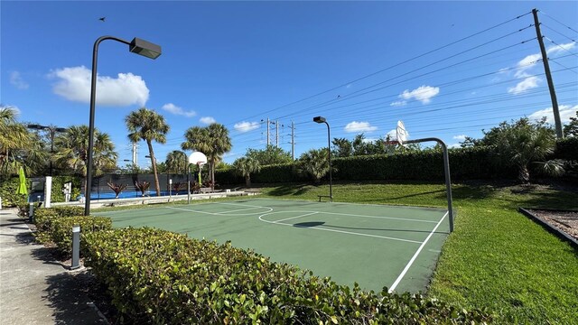 7750 Gardner Dr Unit 102, Naples, FL 34109 - view of basketball court featuring a lawn and community basketball court