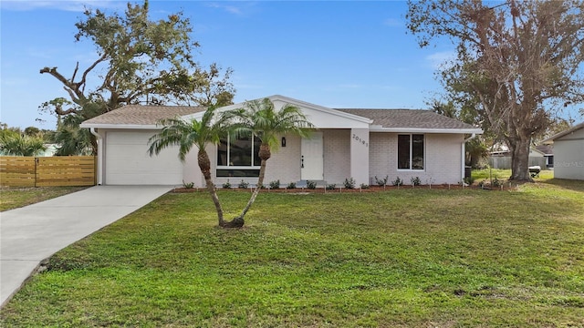 single story home with a front yard and a garage