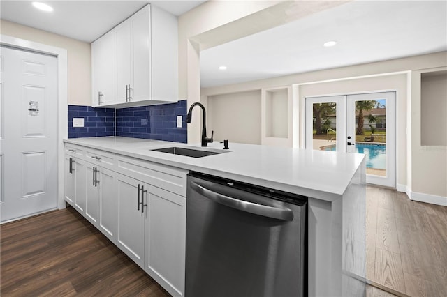 kitchen featuring dishwasher, backsplash, sink, kitchen peninsula, and white cabinetry