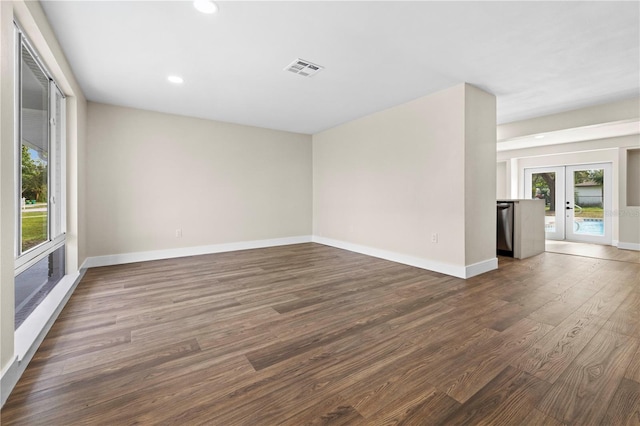 empty room featuring french doors and dark hardwood / wood-style flooring