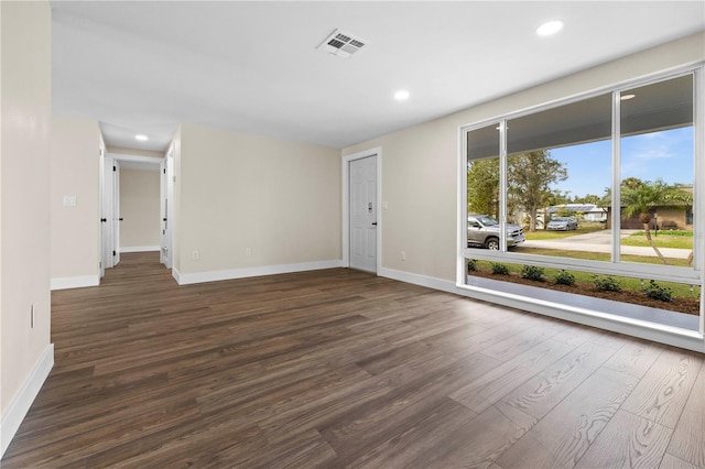 spare room featuring dark wood-type flooring