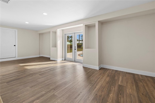 empty room featuring dark hardwood / wood-style floors and french doors