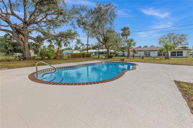 view of pool featuring a yard and a patio