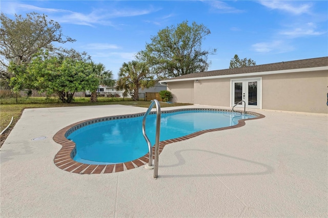 view of pool with a patio area and french doors