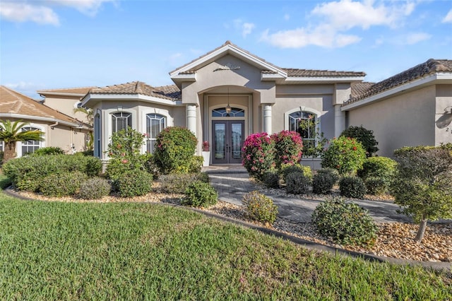 view of front of house featuring french doors and a front lawn