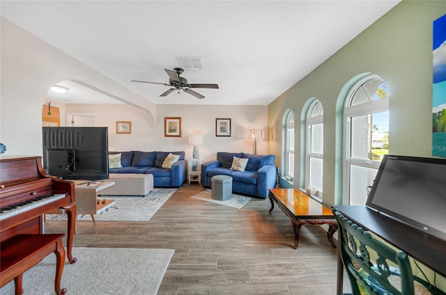 living room with ceiling fan and light wood-type flooring