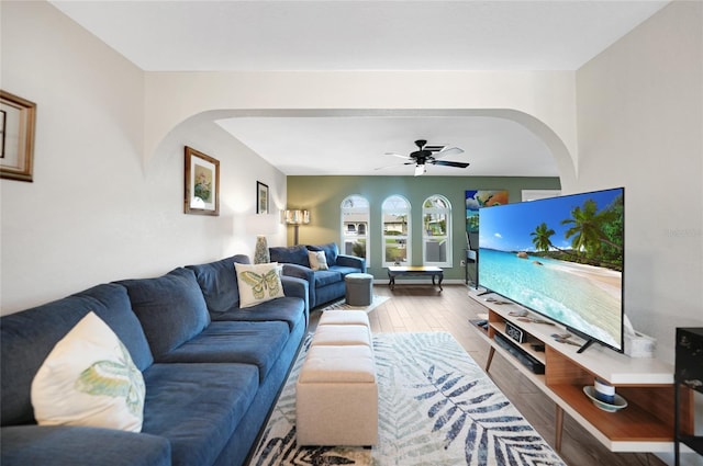 living room with ceiling fan and hardwood / wood-style flooring