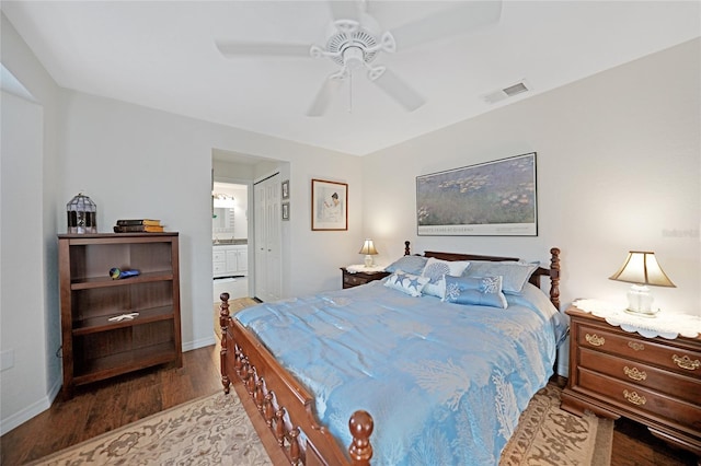 bedroom with hardwood / wood-style floors, ceiling fan, and ensuite bath