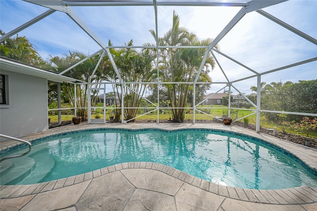 view of pool featuring glass enclosure and a patio area