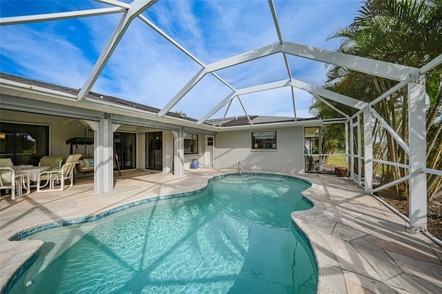 view of swimming pool featuring an outdoor hangout area, a patio area, and a lanai