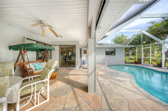 view of pool featuring ceiling fan, a lanai, and a patio