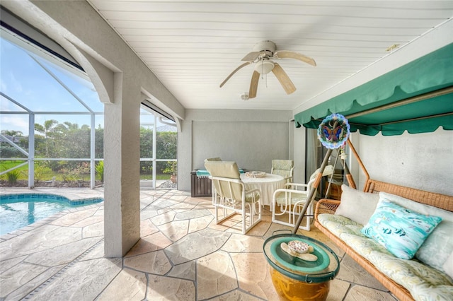 sunroom / solarium with a pool and ceiling fan