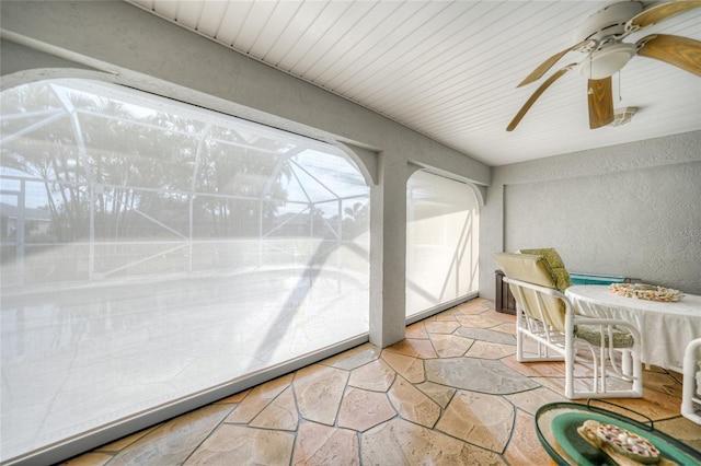 sunroom / solarium featuring ceiling fan