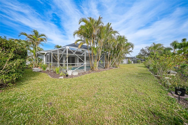 view of yard featuring a lanai and a pool