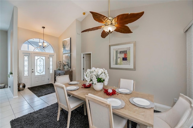 dining room featuring a chandelier, light tile patterned floors, and vaulted ceiling