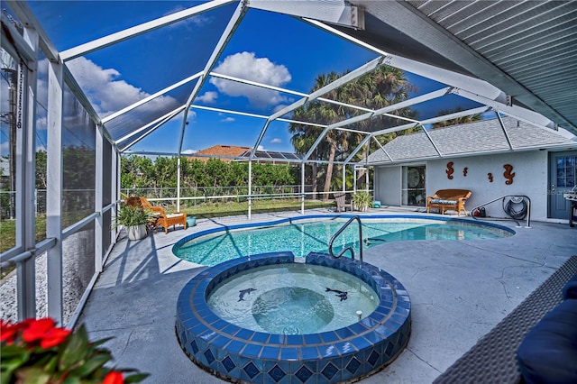 view of swimming pool featuring an in ground hot tub, a patio, and glass enclosure