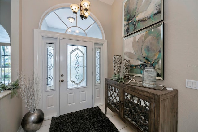 foyer entrance featuring a notable chandelier and light tile patterned flooring