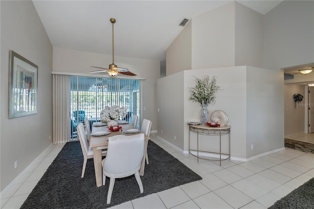 dining area featuring ceiling fan, light tile patterned floors, and lofted ceiling