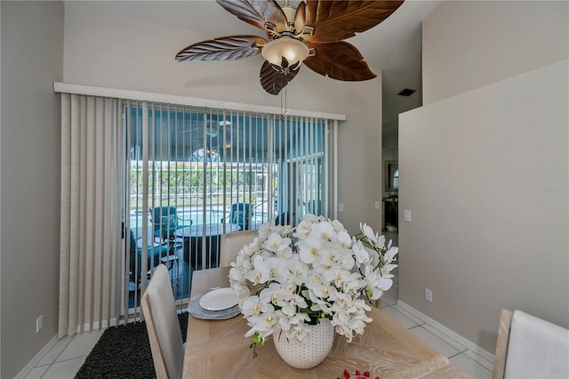 tiled dining space featuring ceiling fan